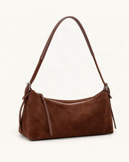 Suede Cowhide Shoulder Bag — front three-quarter view on a warm white background