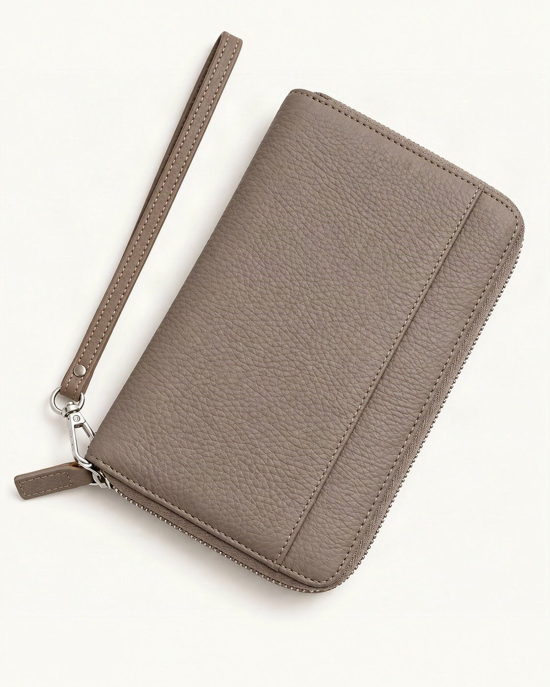Genuine Leather RFID Passport Holder Wallet with Wrist Strap — front three-quarter view on a warm white background