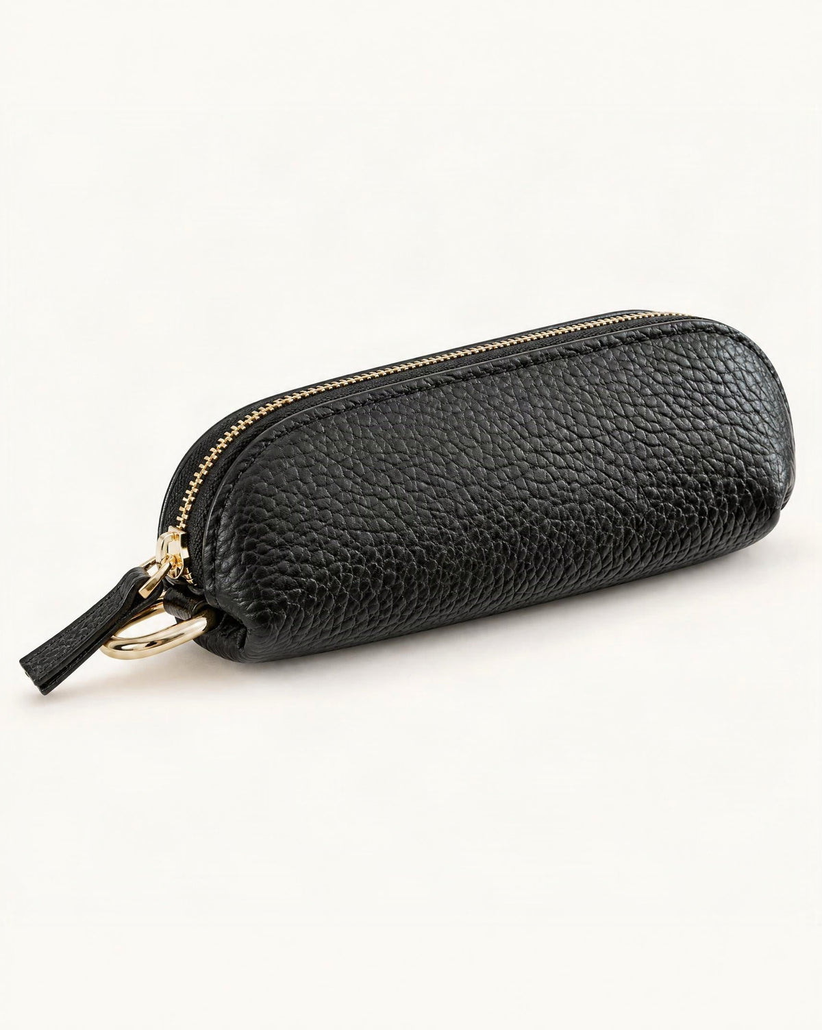 Top-Grain Cowhide Mini Zip Pouch with Keyring Clip — front three-quarter view on a warm white background