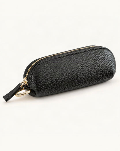 Top-Grain Cowhide Mini Zip Pouch with Keyring Clip — front three-quarter view on a warm white background