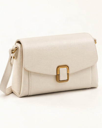 Cowhide Leather Small Crossbody Bag with Adjustable Strap — front three-quarter view on a warm white background