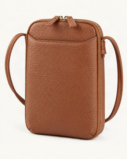 Cowhide Vertical Crossbody Phone Bag, Pebbled — front three-quarter view on a warm white background