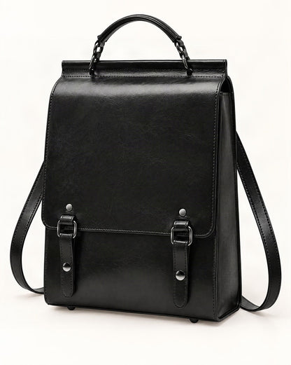 Cowhide Leather Small Backpack with Buckle Flap — front three-quarter view on a warm white background