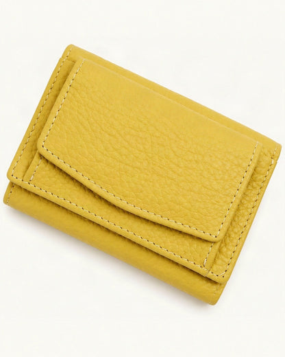 Cowhide Tri-Fold RFID-Blocking Wallet — front three-quarter view on a warm white background