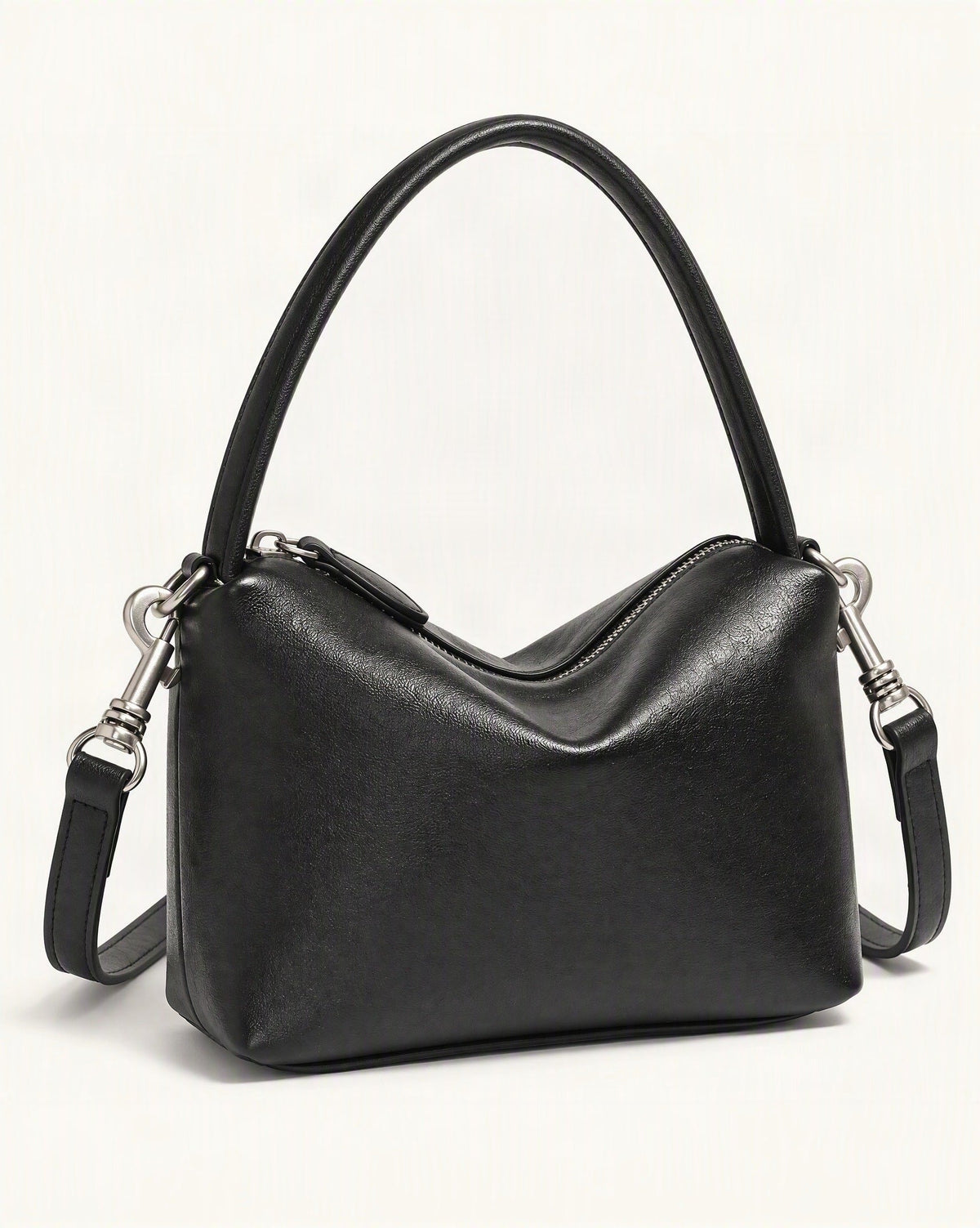 Top-Grain Cowhide Pillow Bag with Detachable Strap — front three-quarter view on a warm white background