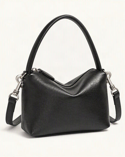 Top-Grain Cowhide Pillow Bag with Detachable Strap — front three-quarter view on a warm white background