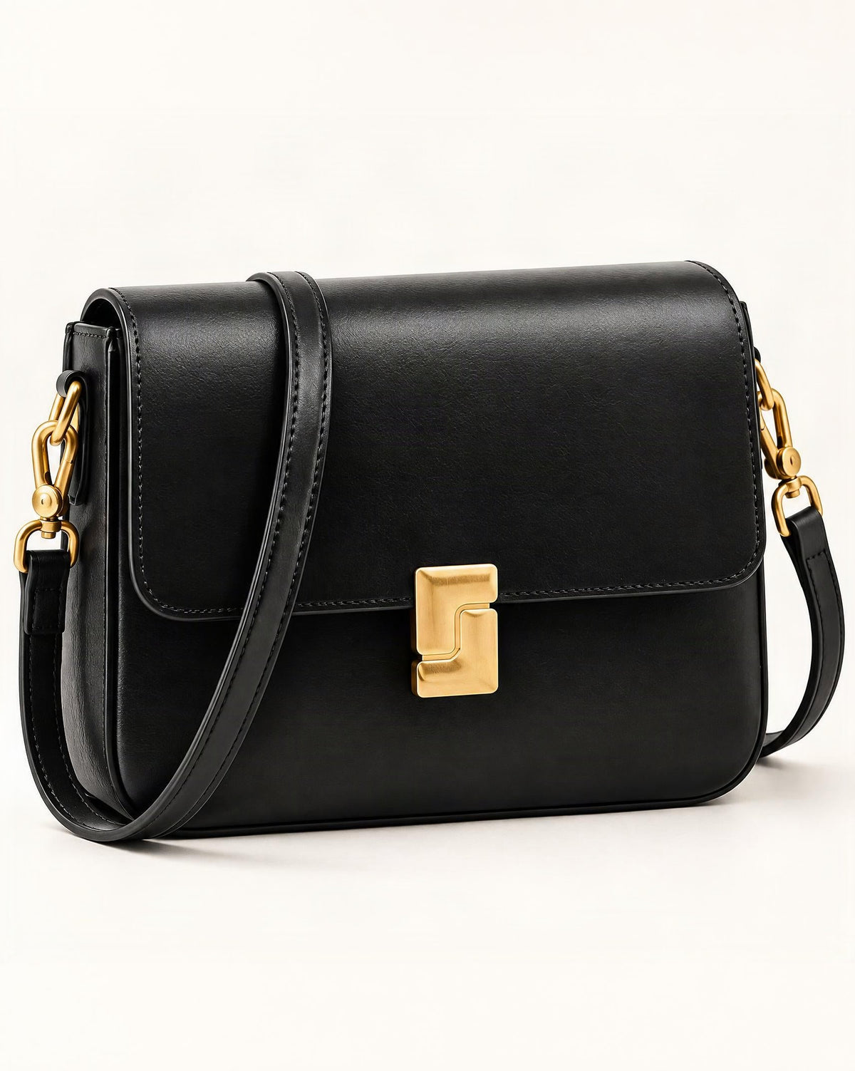 Cowhide Leather Small Crossbody Bag with Turn-Lock Closure — front three-quarter view on a warm white background