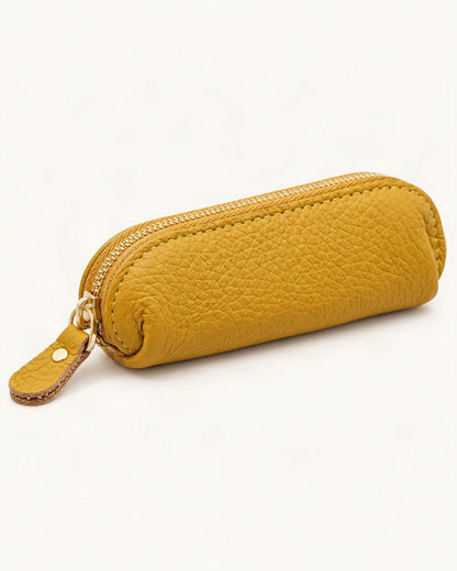 Genuine Leather Mini Coin Pouch with Zipper — front three-quarter view on a warm white background