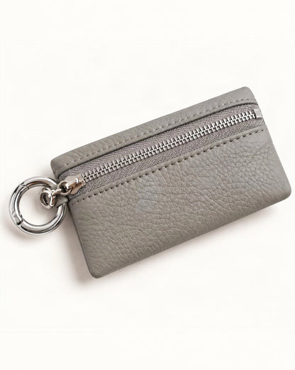 Cowhide Leather Key Chain Coin Pouch — front three-quarter view on a warm white background