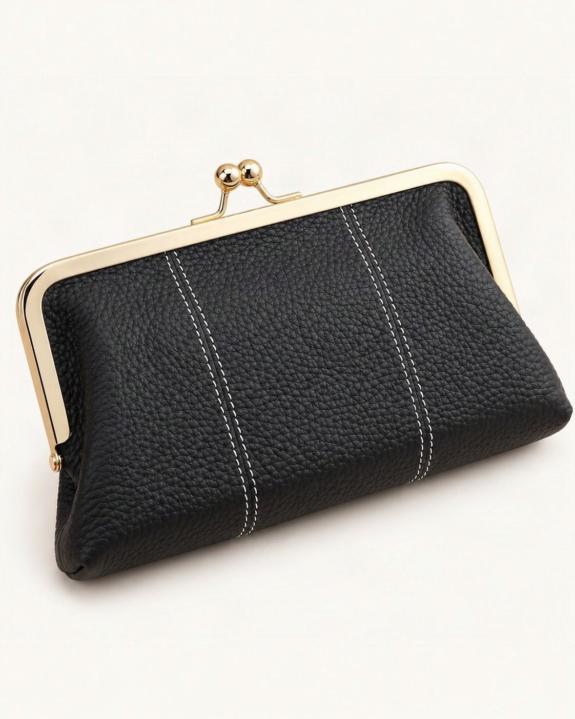 Top-Grain Cowhide Frame Clutch — front three-quarter view on a warm white background