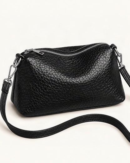 Top-Grain Cowhide Small Shoulder Crossbody Bag — front three-quarter view on a warm white background