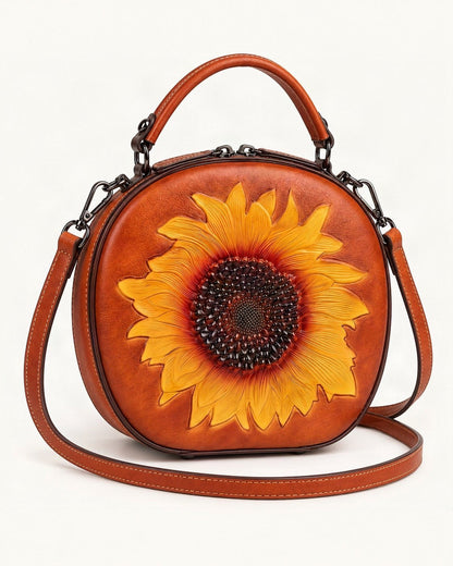 Top-Grain Cowhide Round Crossbody Bag — front three-quarter view on a warm white background