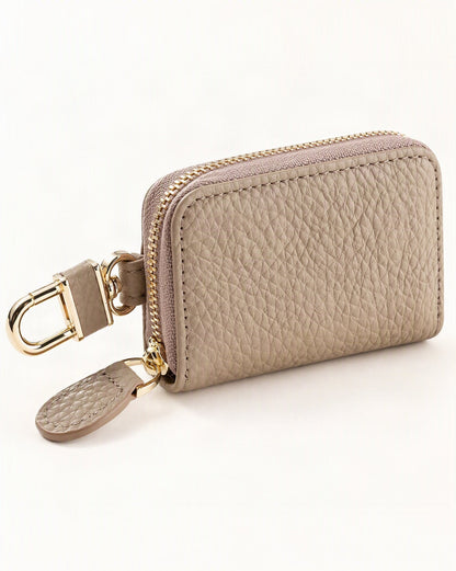 Genuine Leather Zip-Around Key Pouch with Carabiner Clip — front three-quarter view on a warm white background