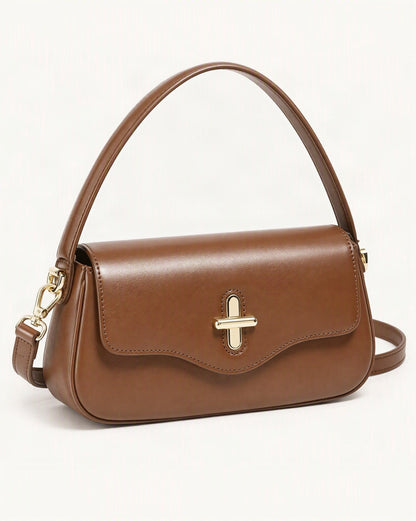 Cowhide Leather Baguette Crossbody Shoulder Top Handle — front three-quarter view on a warm white background