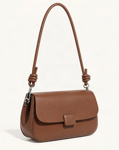 Cowhide Leather Mini Crossbody Bag — front three-quarter view on a warm white background