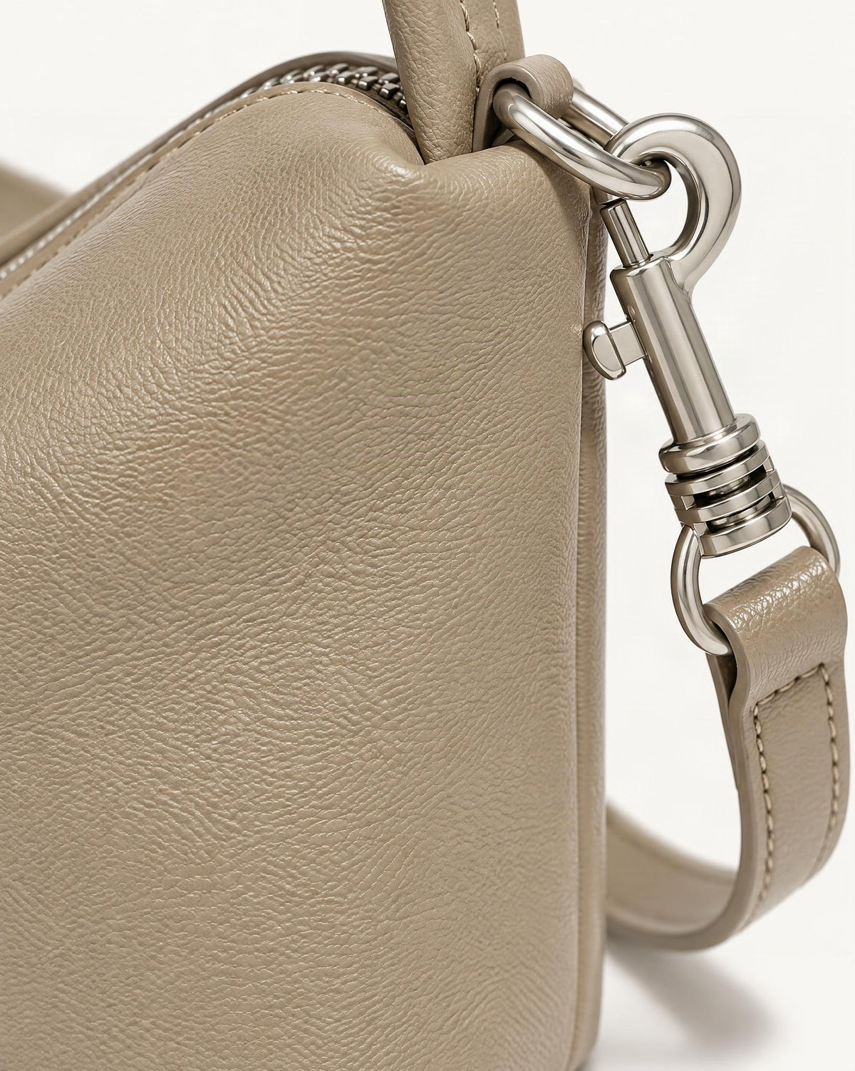 Top-Grain Cowhide Pillow Bag with Detachable Strap hardware and cowhide detail, close up