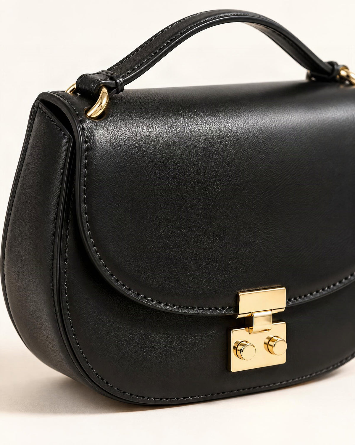 Cowhide Leather Mini Saddle Crossbody Bag with Push Lock hardware and smooth cowhide detail, close up