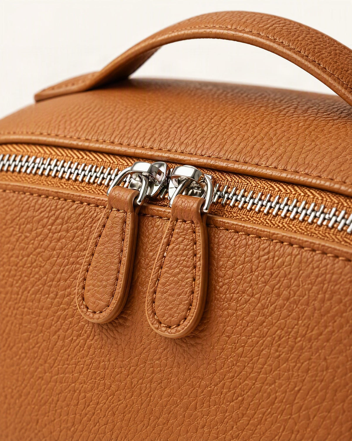 Cowhide Leather Travel Pouch with Top Handle hardware and pebbled cowhide detail, close up