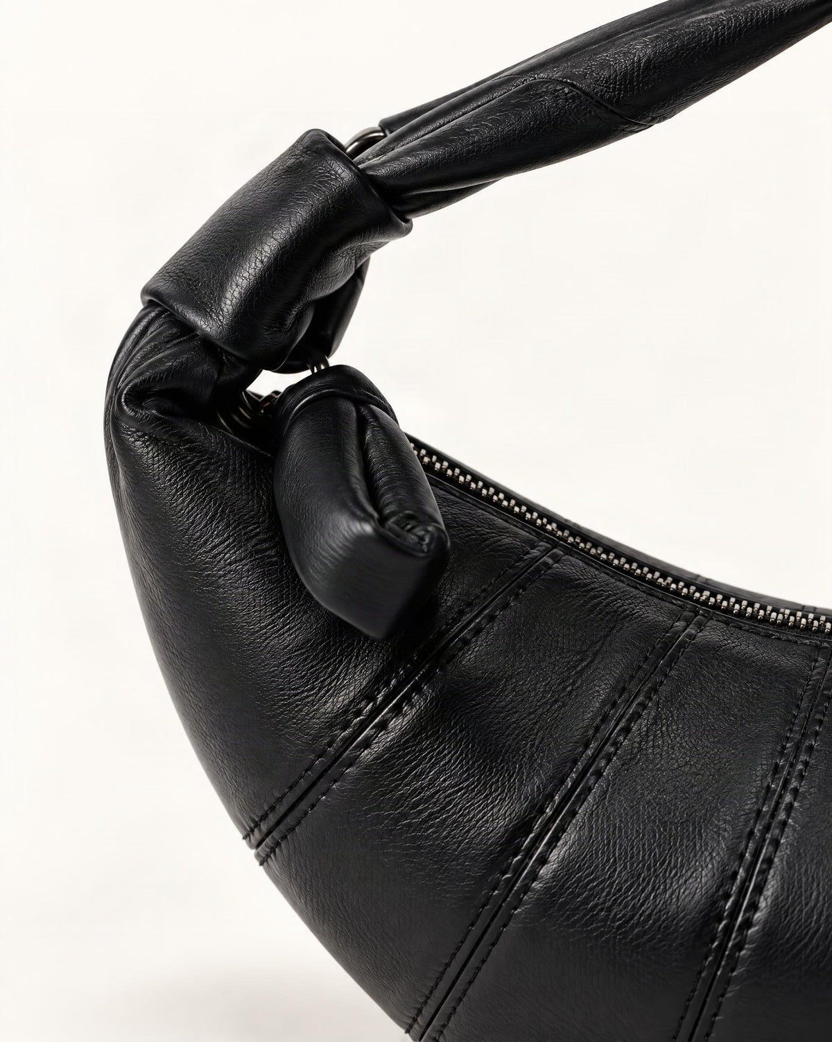 Lambskin Crescent Crossbody Bag with Knotted Strap hardware and lambskin detail, close up