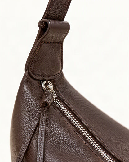 Cowhide Leather Crescent Hobo Crossbody Bag hardware and cowhide detail, close up