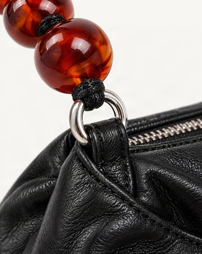 Crinkle Cowhide Mini Crossbody Bag with Beaded Handle hardware and cowhide detail, close up