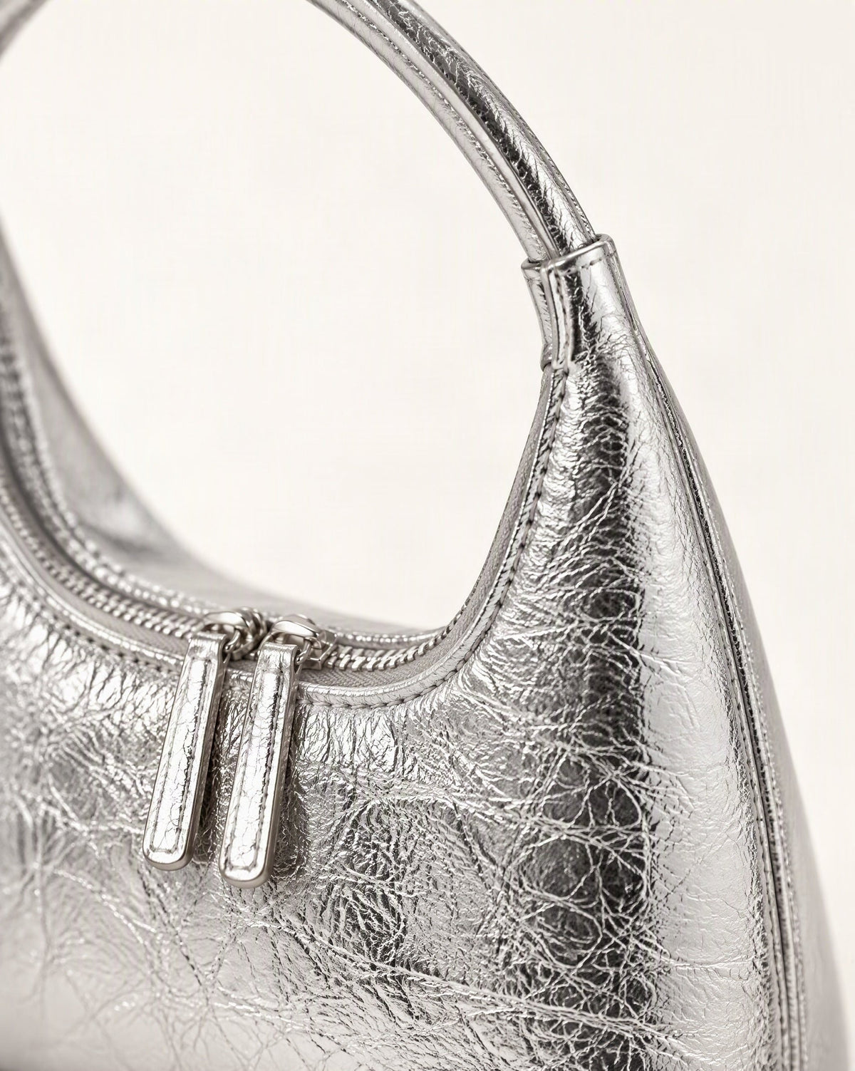Cowhide Mini Top-Handle Hobo Bag with Double Zipper hardware and cowhide detail, close up