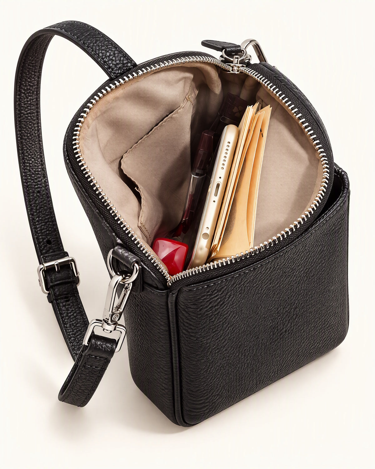 Pebbled Cowhide Micro Crossbody Bag interior, open, holding a phone, cards and a lipstick