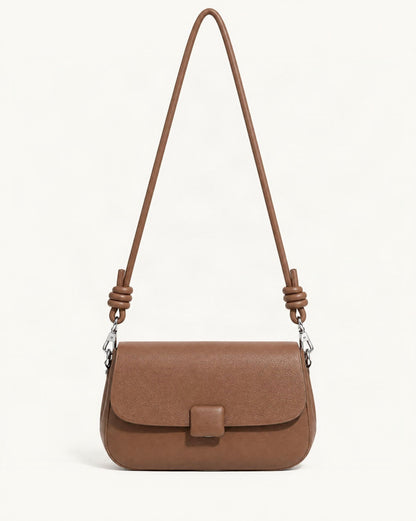 Cowhide Leather Mini Crossbody Bag — straight-on front view on a warm white background