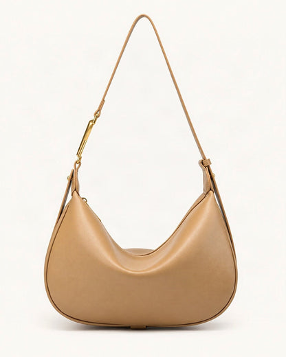 Cowhide Crescent Underarm Bag with X Buckle — straight-on front view on a warm white background