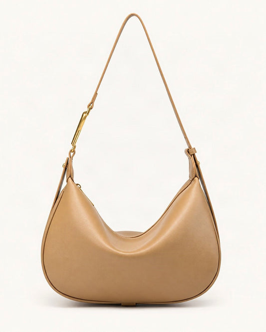 Cowhide Crescent Underarm Bag with X Buckle — straight-on front view on a warm white background