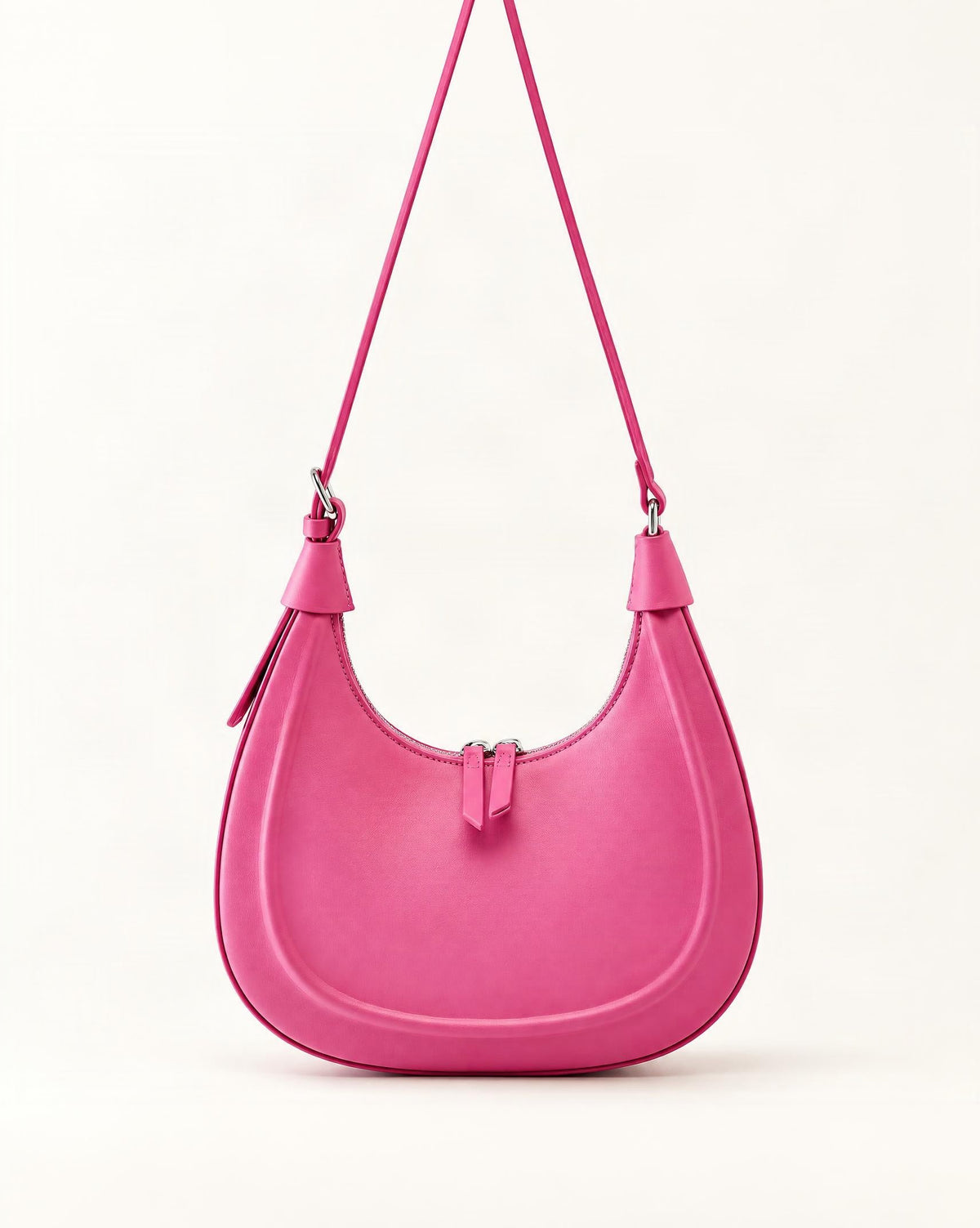 Cowhide Crescent Moon Bag — straight-on front view on a warm white background
