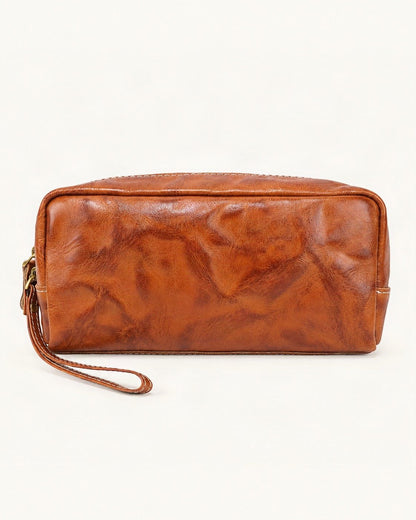 Vegetable-Tanned Leather Cosmetic Wristlet Pouch — straight-on front view on a warm white background