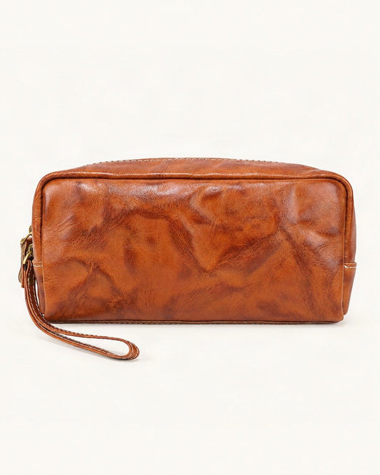 Vegetable-Tanned Leather Cosmetic Wristlet Pouch — straight-on front view on a warm white background