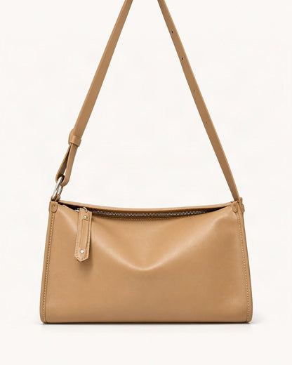 Cowhide Leather Pillow Crossbody Bag — straight-on front view on a warm white background