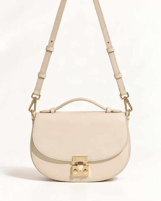Cowhide Leather Mini Saddle Crossbody Bag with Push Lock — straight-on front view on a warm white background