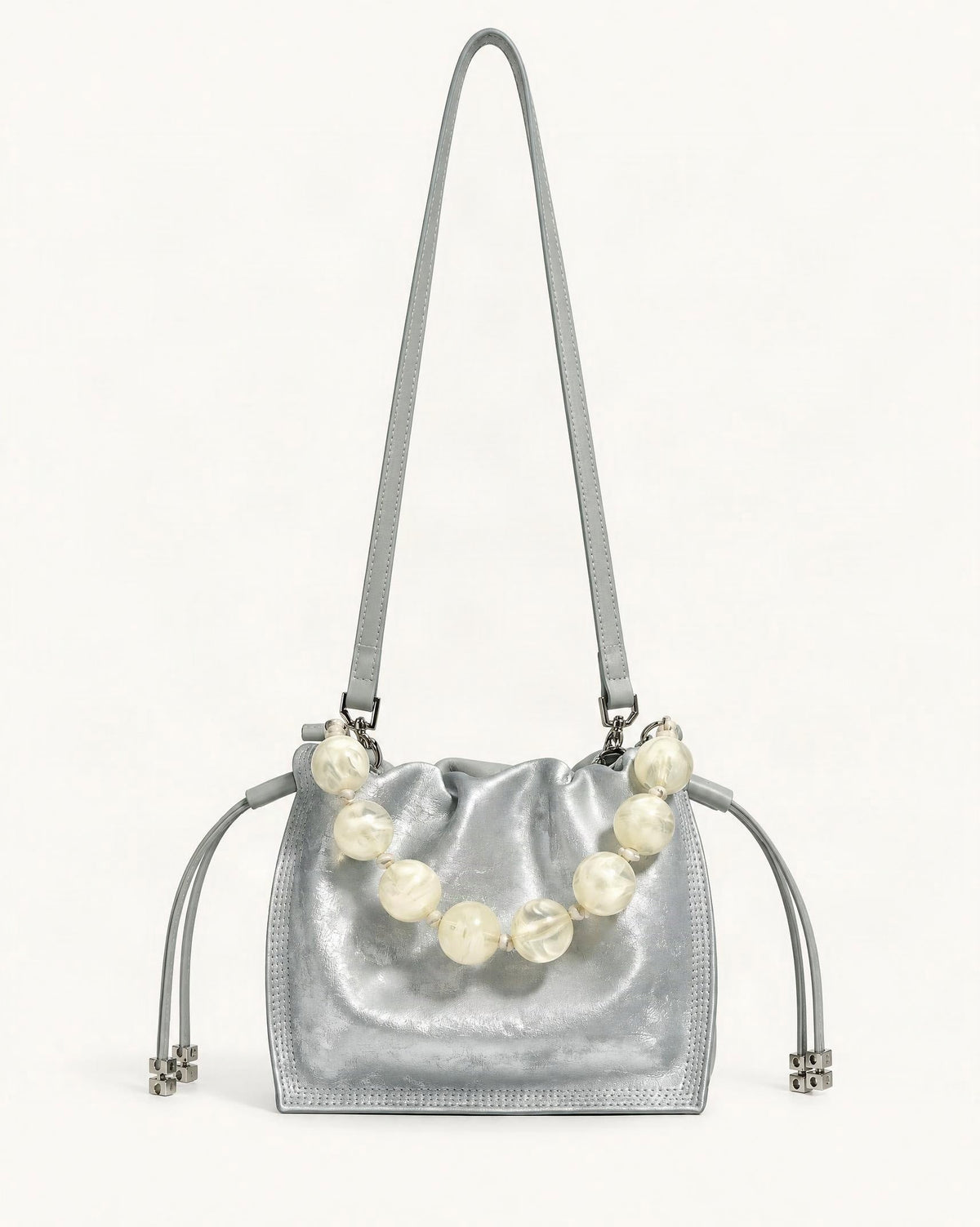 Cowhide Mini Bucket Bag Crossbody Drawstring Bead Handle — straight-on front view on a warm white background