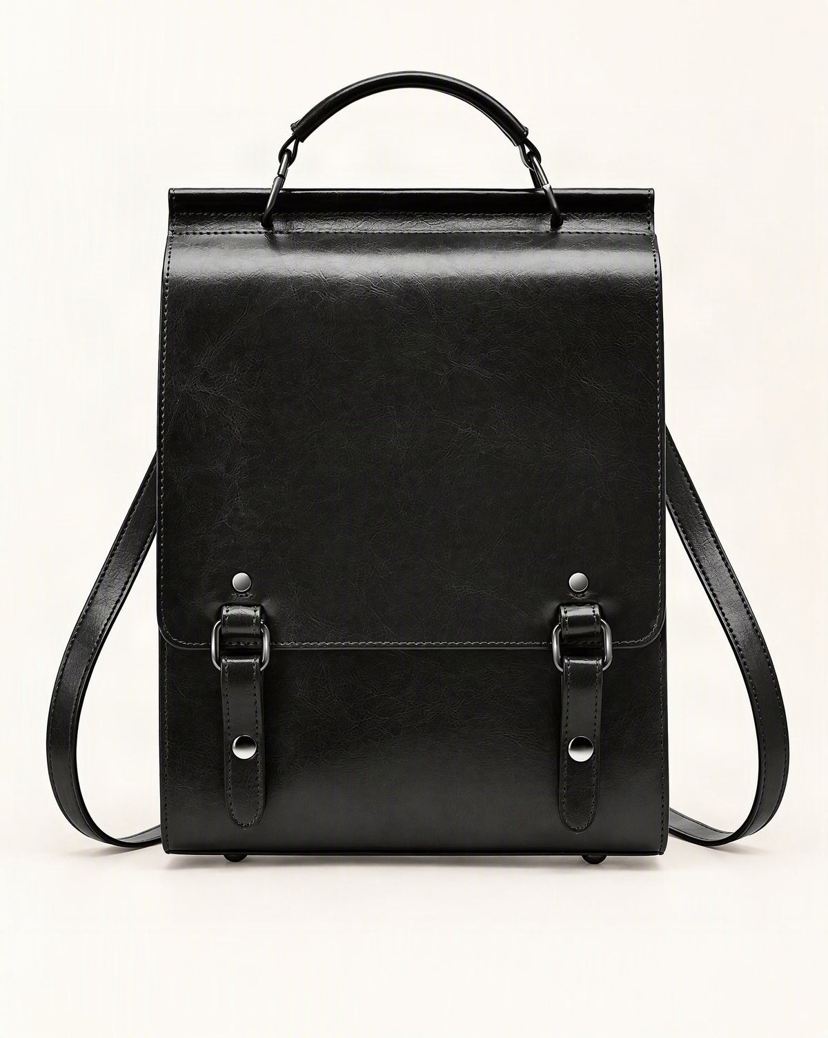 Cowhide Leather Small Backpack with Buckle Flap — straight-on front view on a warm white background