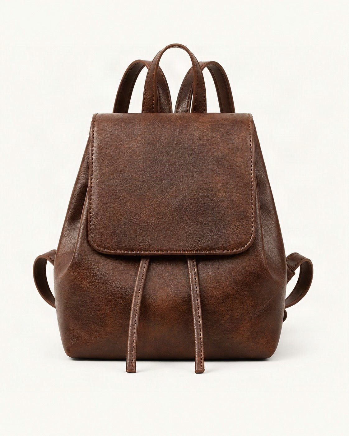 Split Cowhide Mini Backpack — straight-on front view on a warm white background