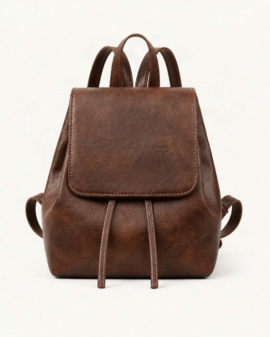Split Cowhide Mini Backpack — straight-on front view on a warm white background