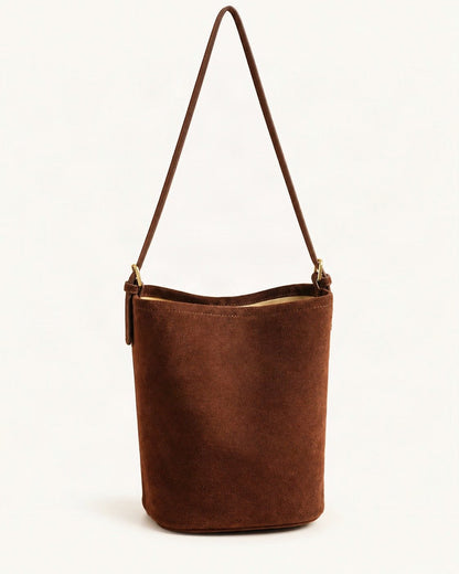 Suede Cowhide Bucket Shoulder Bag — straight-on front view on a warm white background