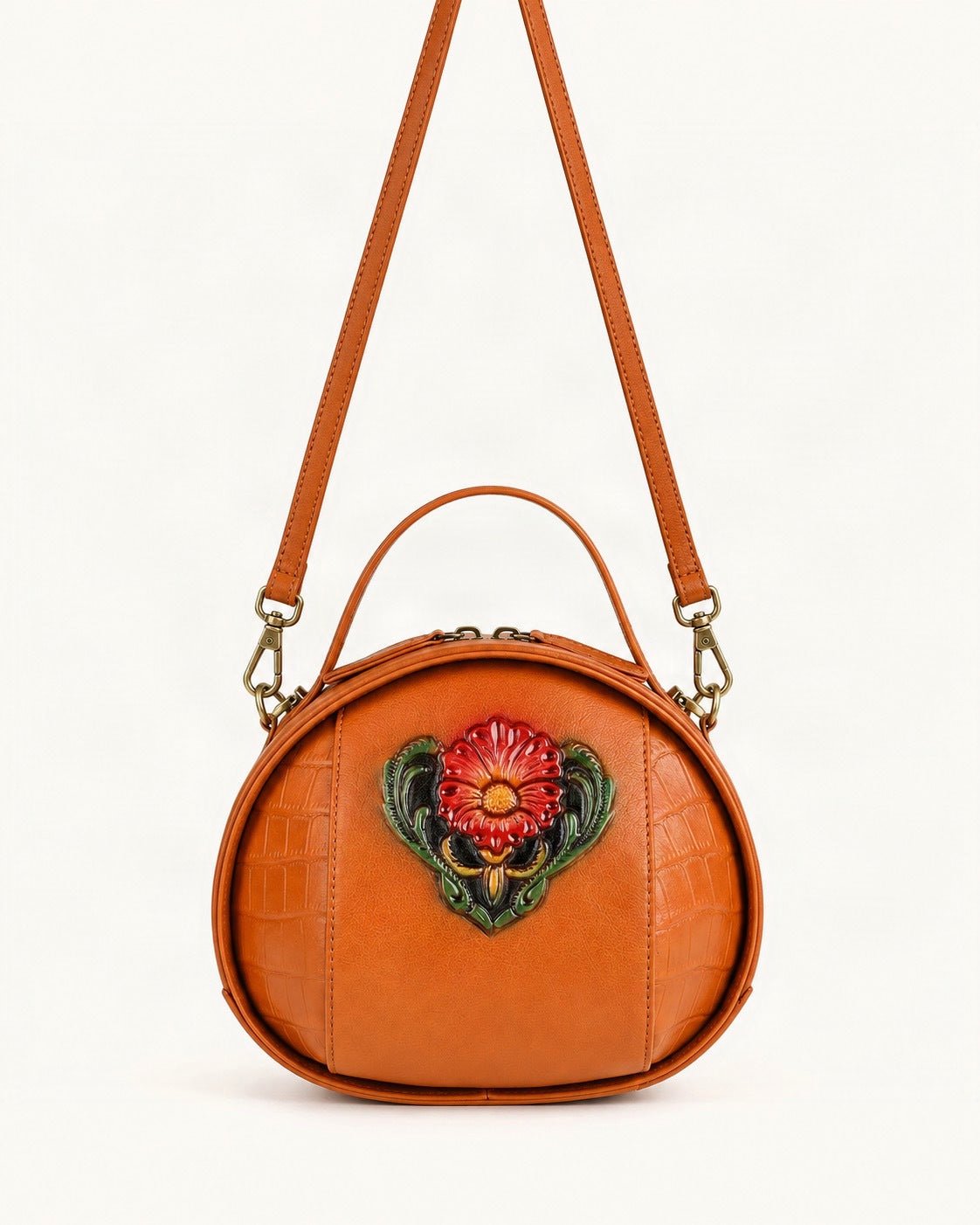 Cowhide Embossed Round Crossbody Bag — straight-on front view on a warm white background