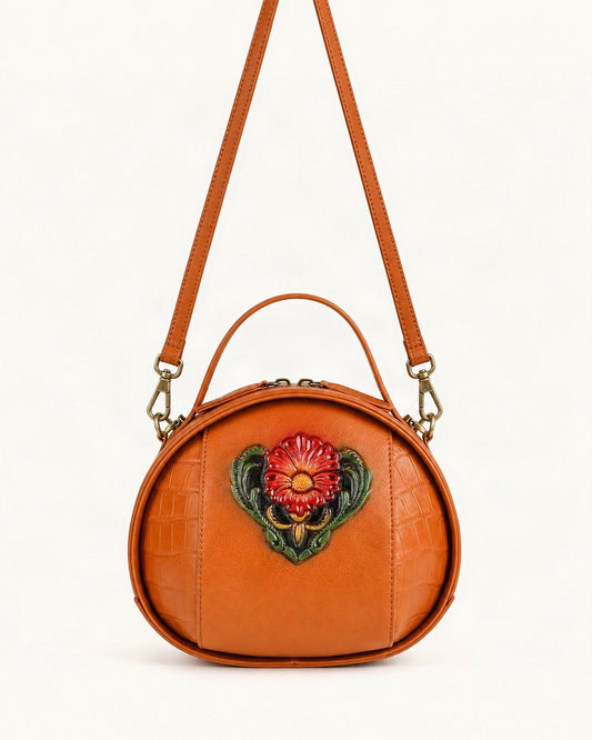 Cowhide Embossed Round Crossbody Bag — straight-on front view on a warm white background