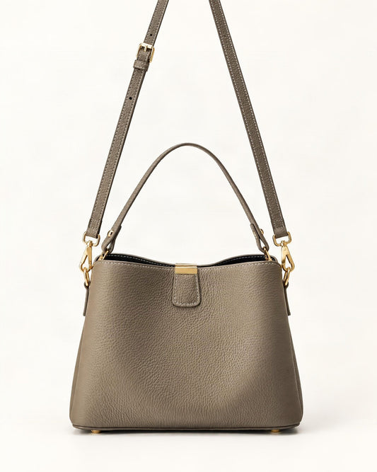 Cowhide Leather Crescent Bucket Bag — straight-on front view on a warm white background