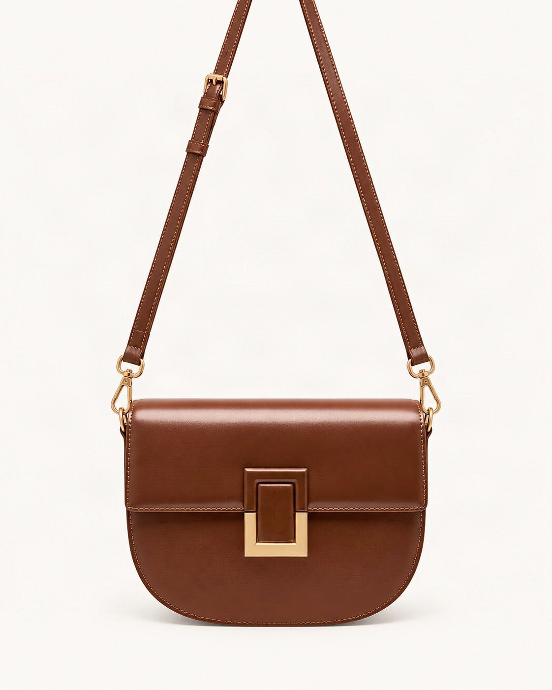 Cowhide Mini Saddle Crossbody Bag — straight-on front view on a warm white background