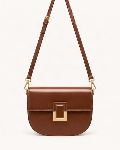 Cowhide Mini Saddle Crossbody Bag — straight-on front view on a warm white background