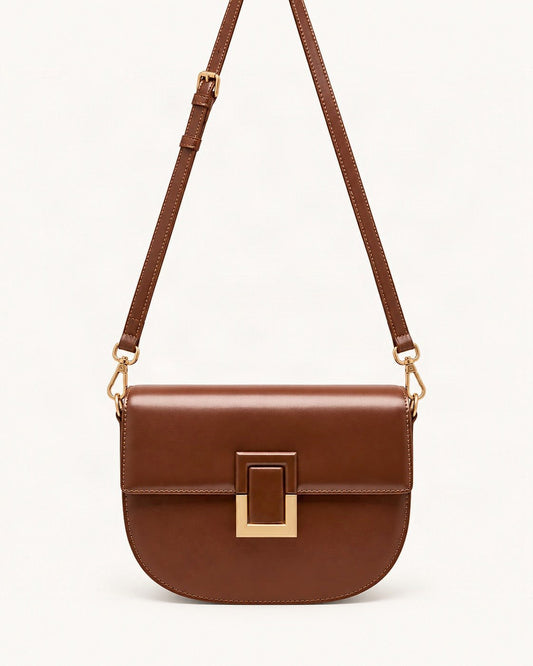 Cowhide Mini Saddle Crossbody Bag — straight-on front view on a warm white background