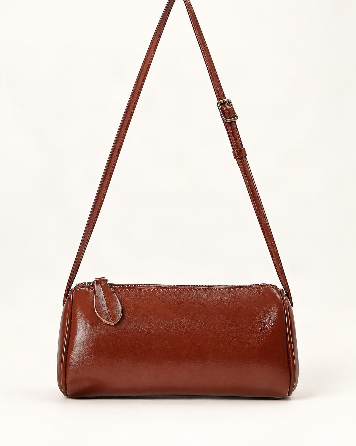Top-Grain Cowhide Mini Barrel Crossbody Bag — straight-on front view on a warm white background