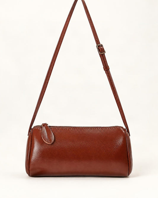Top-Grain Cowhide Mini Barrel Crossbody Bag — straight-on front view on a warm white background
