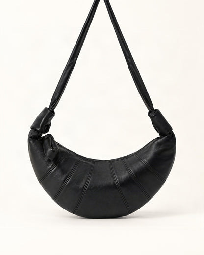 Lambskin Crescent Crossbody Bag with Knotted Strap — straight-on front view on a warm white background