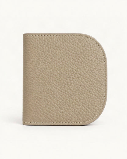 Cowhide Leather Compact Bifold Wallet — straight-on front view on a warm white background